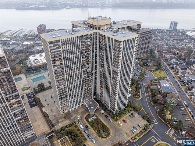 birds eye view of property with a city view and a water view