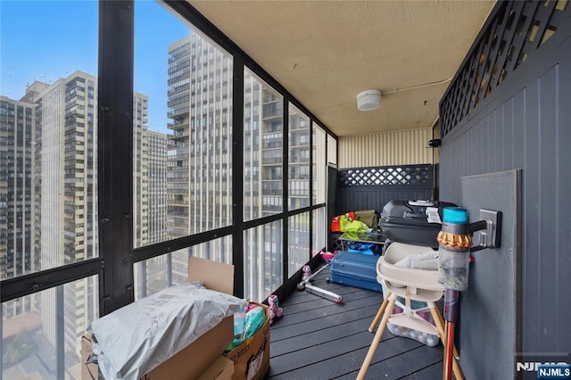 balcony with a city view and area for grilling