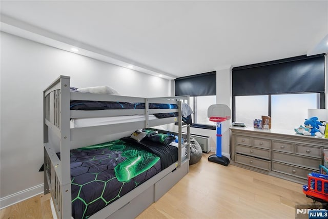 bedroom featuring baseboards and wood finished floors