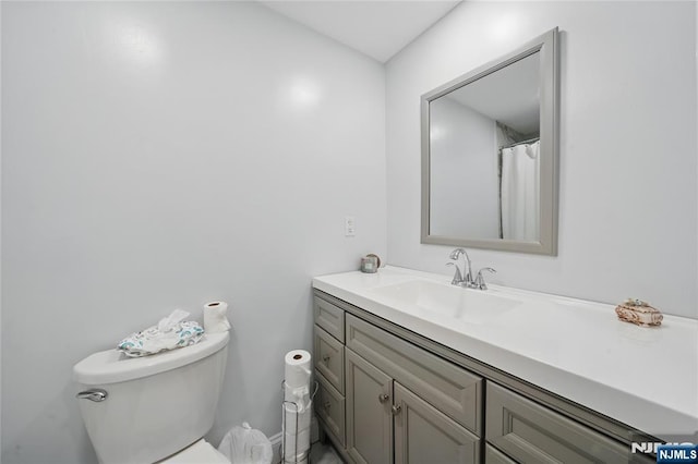full bath featuring toilet and vanity
