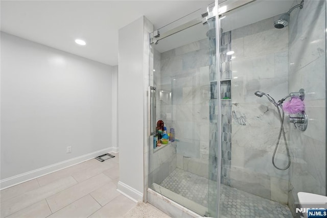 full bath with tile patterned flooring, baseboards, and a stall shower