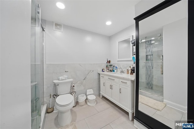 bathroom featuring visible vents, a shower stall, vanity, and toilet