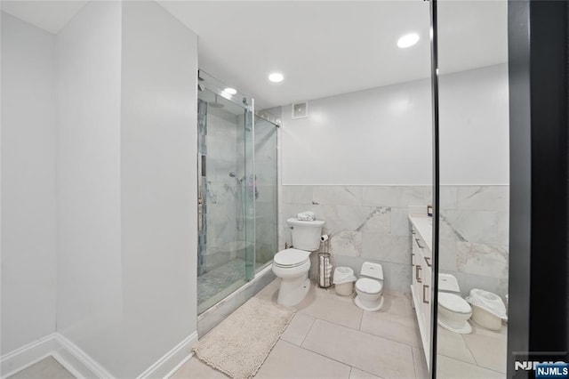 full bath with tile patterned flooring, toilet, recessed lighting, a stall shower, and tile walls