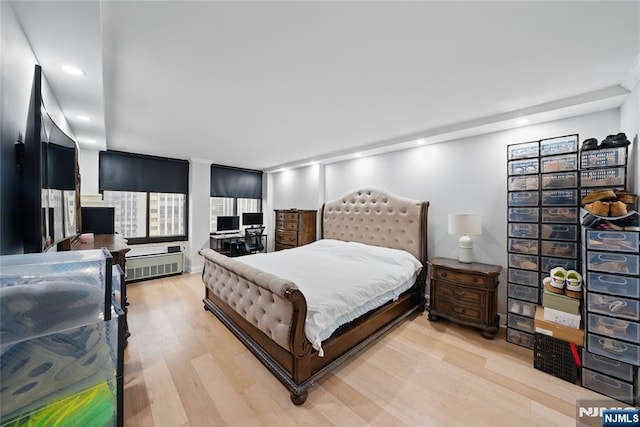 bedroom featuring recessed lighting, radiator, and light wood-style floors