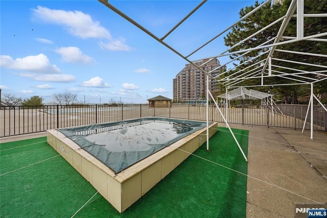 view of swimming pool featuring fence