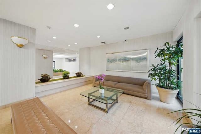 living area with recessed lighting and visible vents