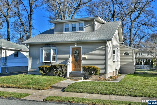 33 Bergen Ave, Waldwick, NJ 07463 - bungalow featuring entry steps, a front lawn, fence, and a shingled roof