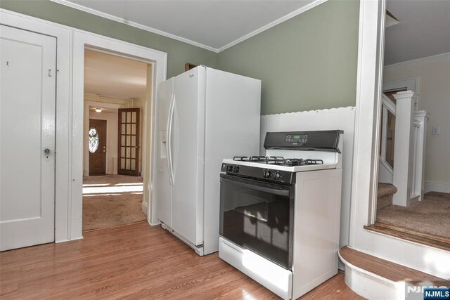 33 Bergen Ave, Waldwick, NJ 07463 - kitchen featuring range with gas stovetop, crown molding, white refrigerator with ice dispenser, and light wood finished floors