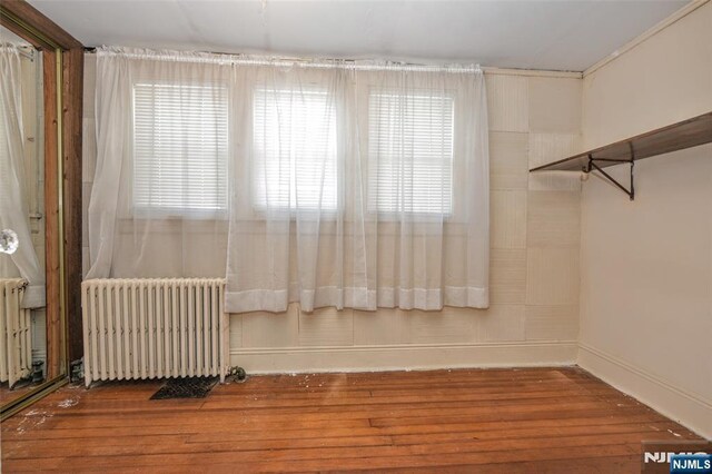 33 Bergen Ave, Waldwick, NJ 07463 - empty room with radiator heating unit, wood finished floors, and baseboards