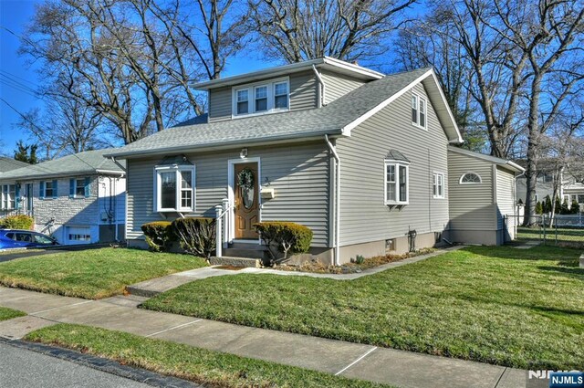 33 Bergen Ave, Waldwick, NJ 07463 - bungalow featuring roof with shingles, a front yard, and fence