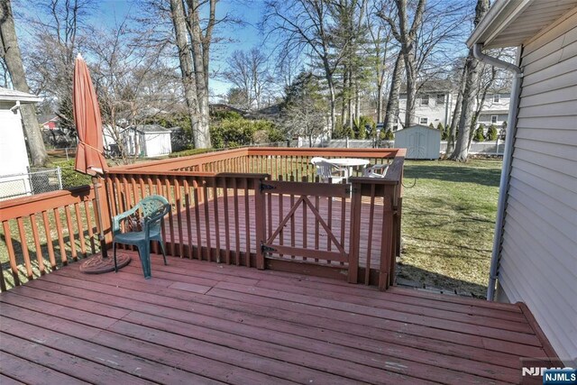 33 Bergen Ave, Waldwick, NJ 07463 - wooden deck with an outbuilding, a storage unit, a yard, and fence