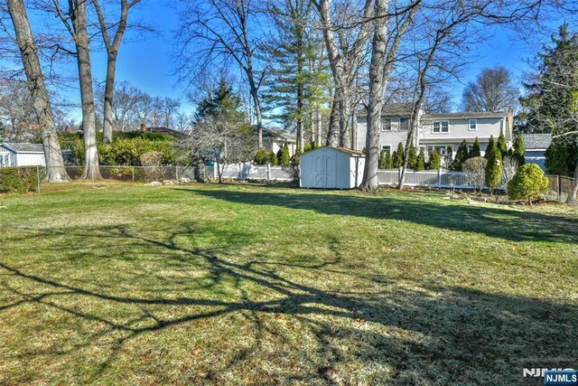 33 Bergen Ave, Waldwick, NJ 07463 - view of yard featuring a storage unit, a fenced backyard, and an outdoor structure