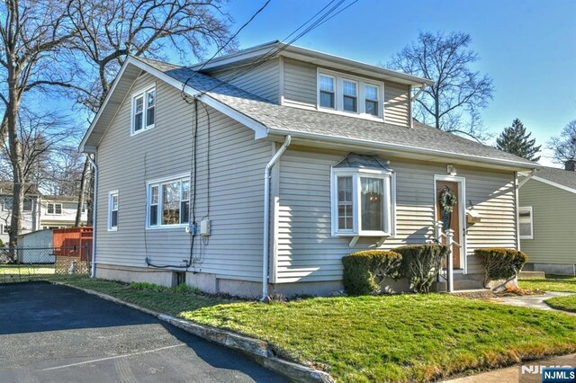 33 Bergen Ave, Waldwick, NJ 07463 - view of side of property with a yard, fence, and roof with shingles