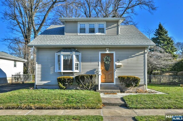 33 Bergen Ave, Waldwick, NJ 07463 - bungalow-style house with entry steps, a front yard, fence, and roof with shingles