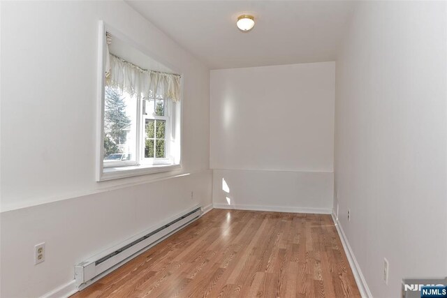 33 Bergen Ave, Waldwick, NJ 07463 - empty room featuring light wood finished floors, a baseboard heating unit, and baseboards