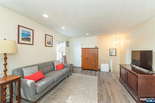 living room with recessed lighting and light wood finished floors
