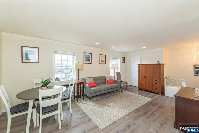 living room featuring recessed lighting, plenty of natural light, and light wood-style floors