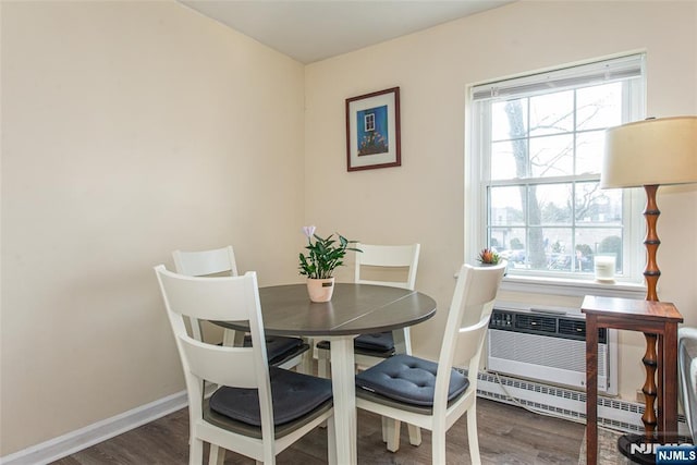 dining room with plenty of natural light, baseboards, and wood finished floors