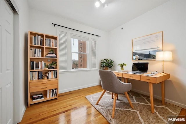 office area with baseboards and wood finished floors