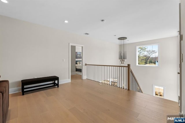 living area with baseboards, visible vents, wood finished floors, and recessed lighting