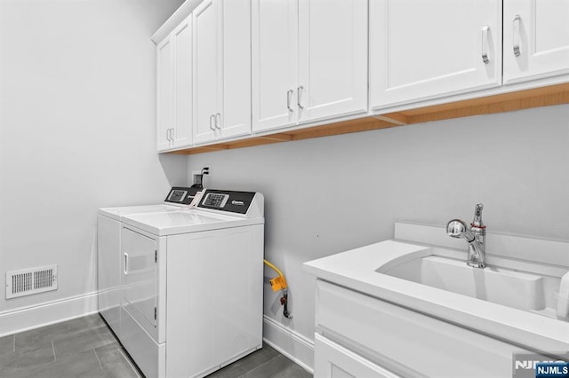 clothes washing area featuring independent washer and dryer, baseboards, a sink, visible vents, and cabinet space