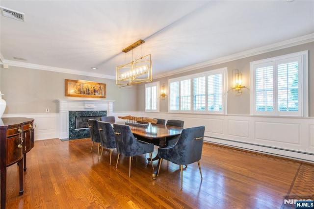 dining area featuring crown molding, a wealth of natural light, and visible vents