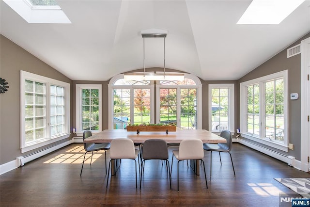 dining room with vaulted ceiling with skylight, baseboards, baseboard heating, and dark wood-style flooring