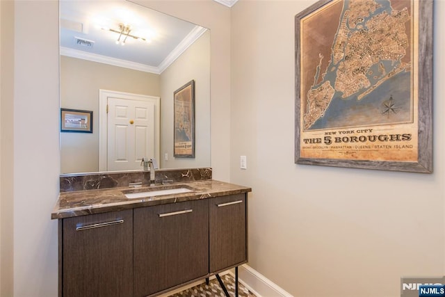 bathroom with visible vents, ornamental molding, baseboards, and vanity