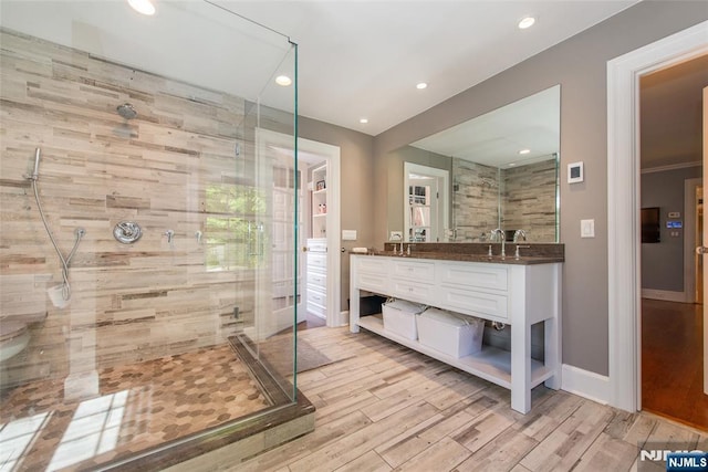bathroom featuring a shower stall, recessed lighting, and wood finished floors