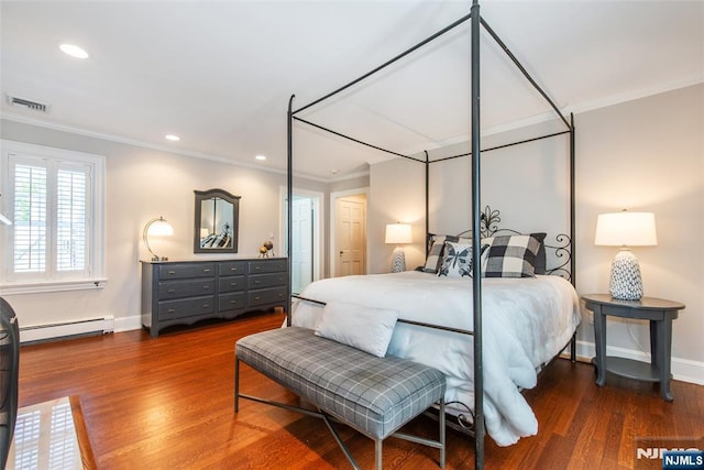 bedroom featuring visible vents, ornamental molding, baseboard heating, and wood finished floors