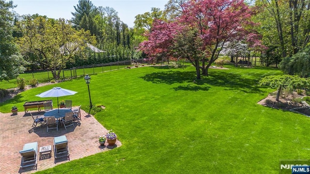 view of yard featuring fence and a patio area