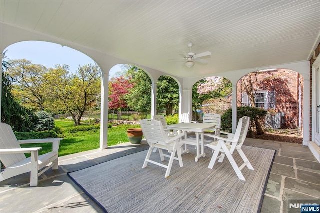 view of patio / terrace featuring fence, outdoor dining space, and ceiling fan