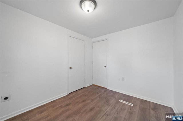 unfurnished room featuring wood finished floors and baseboards