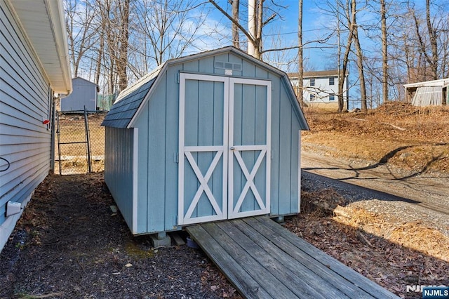 view of shed featuring fence
