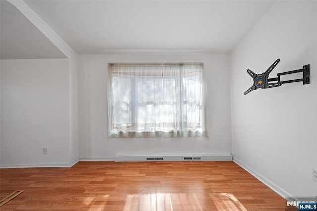 unfurnished room with visible vents, baseboards, and light wood-style floors
