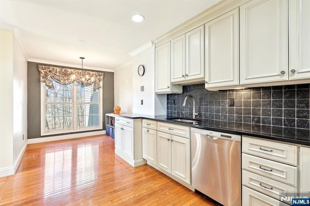 kitchen featuring a sink, ornamental molding, a chandelier, and stainless steel dishwasher