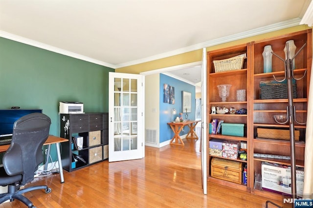 home office with crown molding, french doors, wood finished floors, baseboards, and visible vents