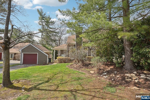 view of front of home with a front lawn, driveway, a garage, and a chimney