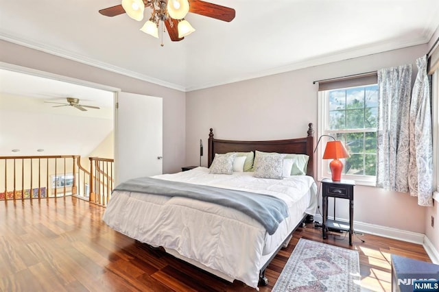 bedroom featuring baseboards, crown molding, wood finished floors, and ceiling fan