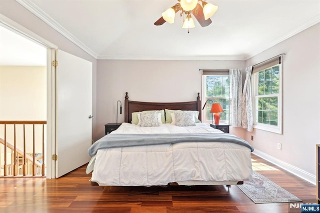 bedroom featuring baseboards, crown molding, wood finished floors, and a ceiling fan