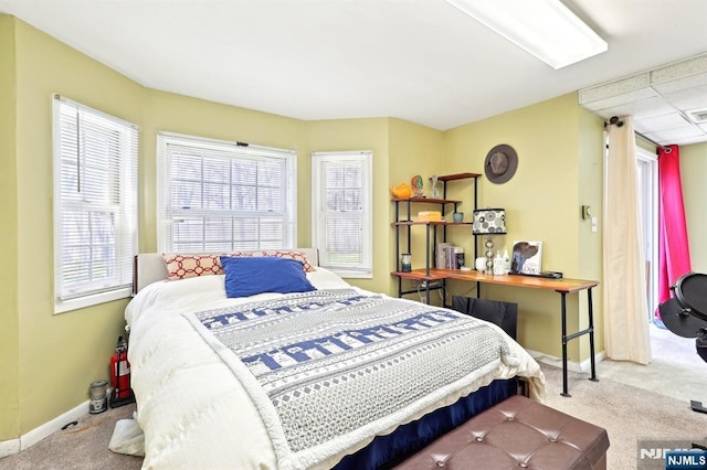 bedroom with baseboards, visible vents, and carpet flooring