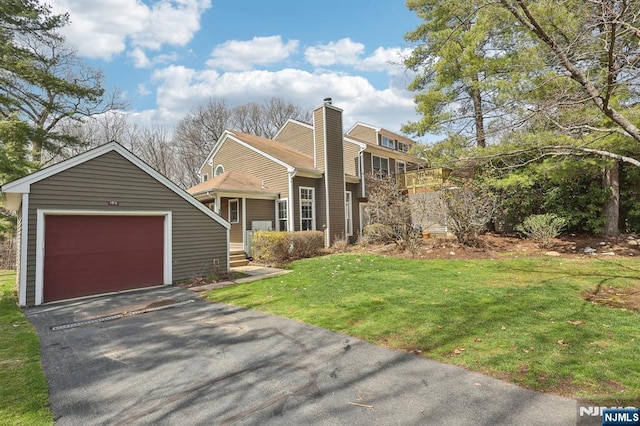 view of front of house with a front yard, driveway, and an attached garage