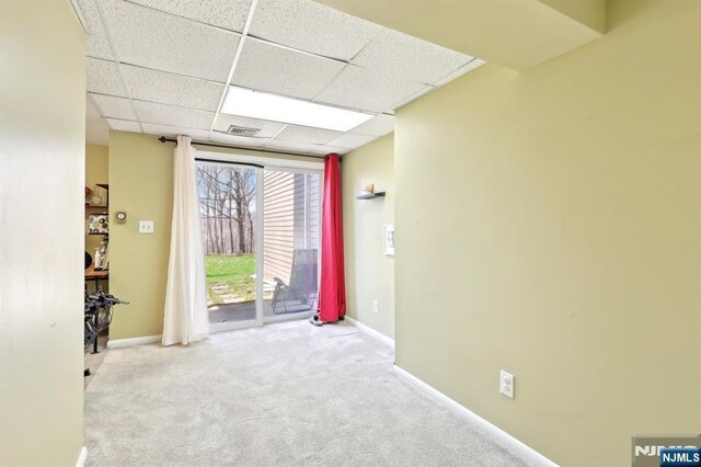 interior space with baseboards, visible vents, carpet flooring, and a paneled ceiling