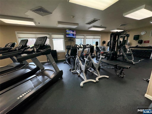 gym featuring baseboards and visible vents