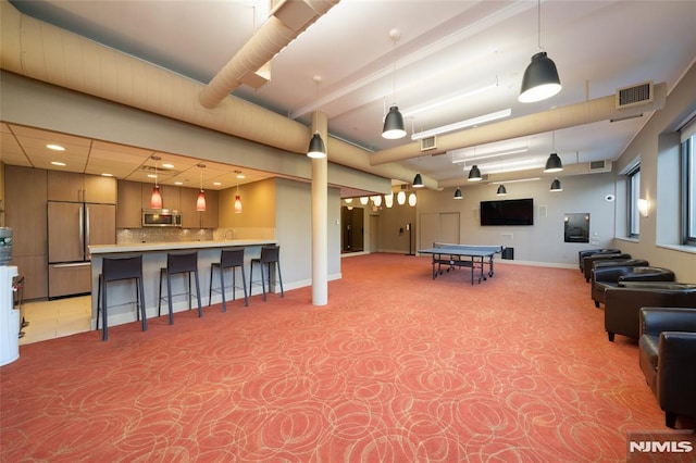 game room featuring baseboards, visible vents, and carpet flooring