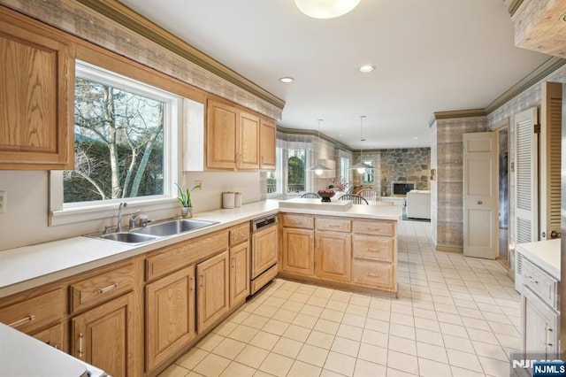 kitchen featuring light countertops, paneled dishwasher, crown molding, a peninsula, and a sink