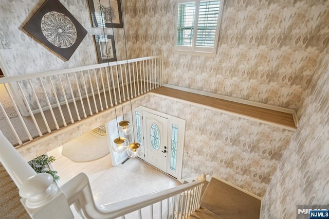 stairs with wallpapered walls