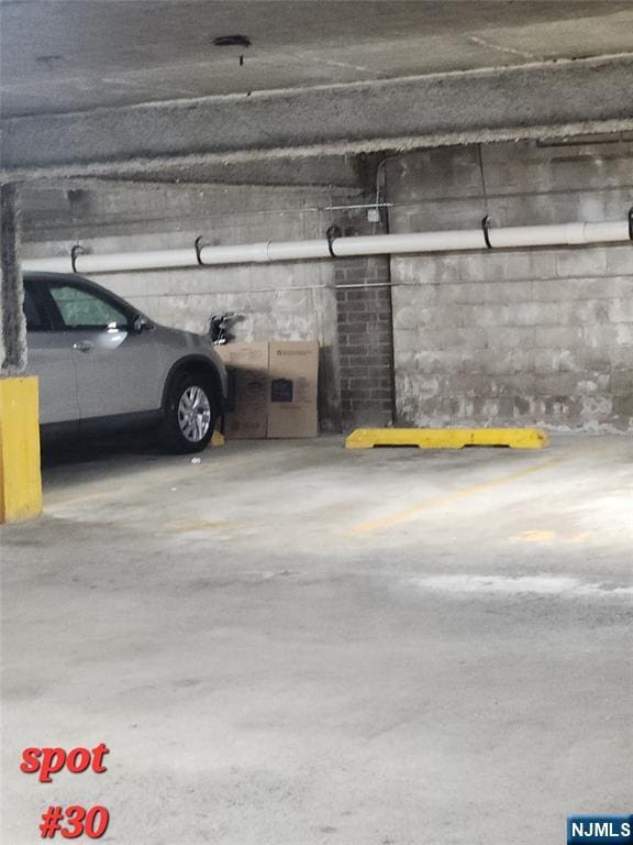parking deck featuring concrete block wall