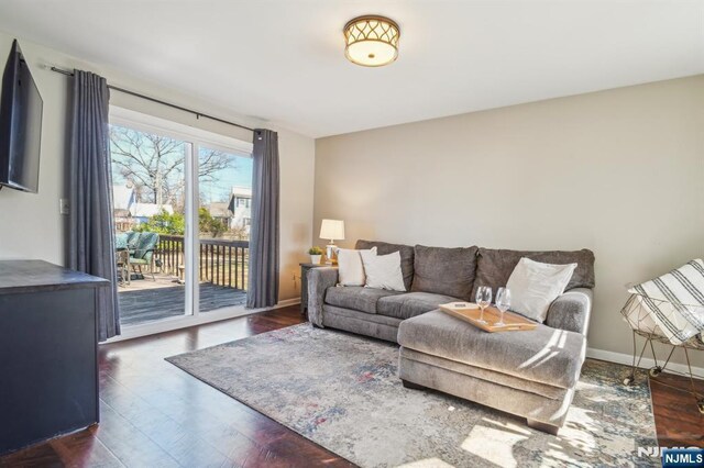 living room featuring baseboards and wood finished floors