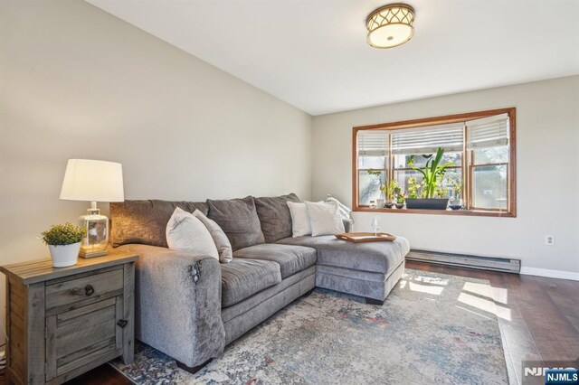 living room with baseboards, lofted ceiling, wood finished floors, and a baseboard heating unit